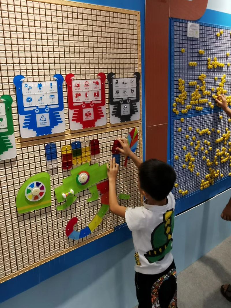 Little boy in kindergarten playing the wall games